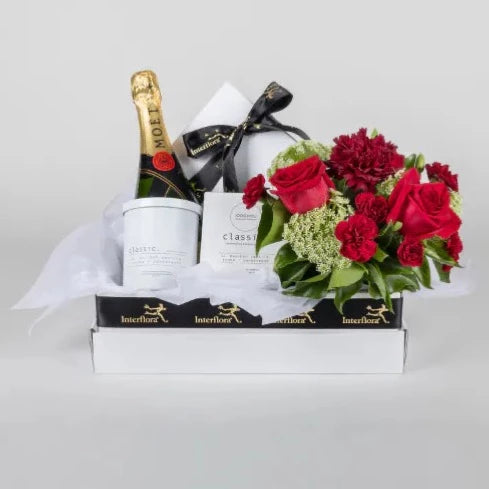 Deluxe Romance Hamper  Spoil your Partner this year with Sparkling Sweet Love. The Romance Hamper features stunning flowers in a vase, chocolates, Moet Champagne and a candle. If you’re looking for romance, this is the perfect gift!