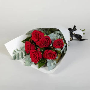 6 Red Rose Bouquet  Show your appreciation for a special someone with this beautiful fresh rose bouquet. La vie en rosé features 6 fresh red roses wrapped and tied with ribbon. Add wine or chocolates to these romantic flowers to treat them even more.