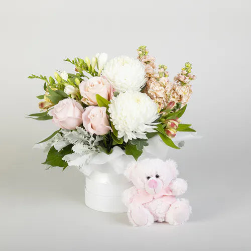 Pink Flower Arrangement With Teddy Bear  Celebrate a new baby girl with this flower delivery. A beautiful pink flower arrangement featuring chrysanthemums and roses sits inside a cute box with a baby pink teddy. Ideal for delivery to a hospital or home.